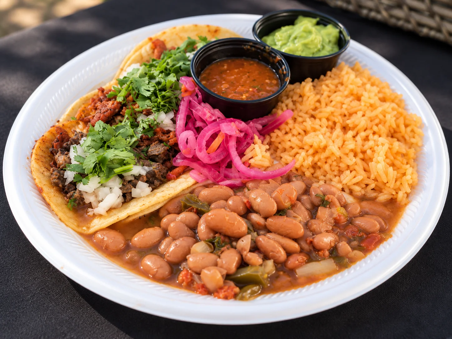 Taco plate with rice, charro beans, salsa and guacamole
