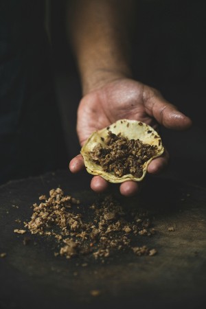 Fresh taco being prepared by hand